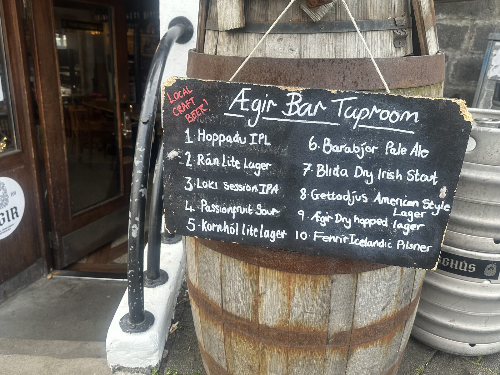 Chalkboard tap list on a barrel outside ÆGIR 101